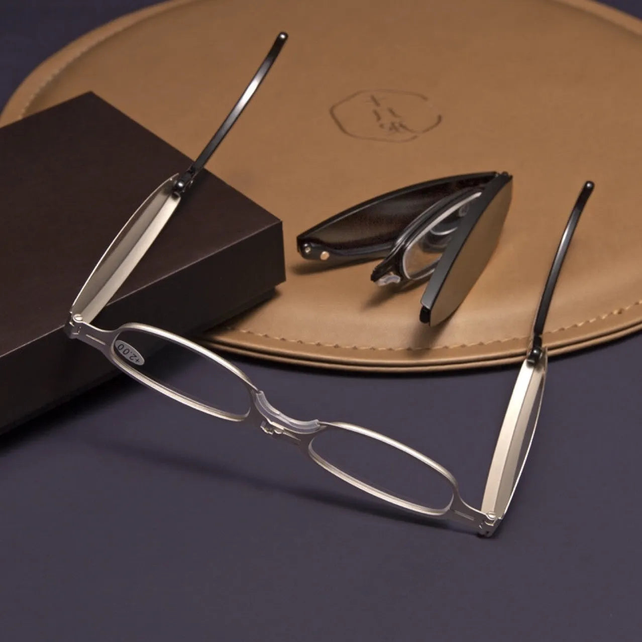 Folding pocket presbyopic glasses with retro frame, shown in black and silver colours