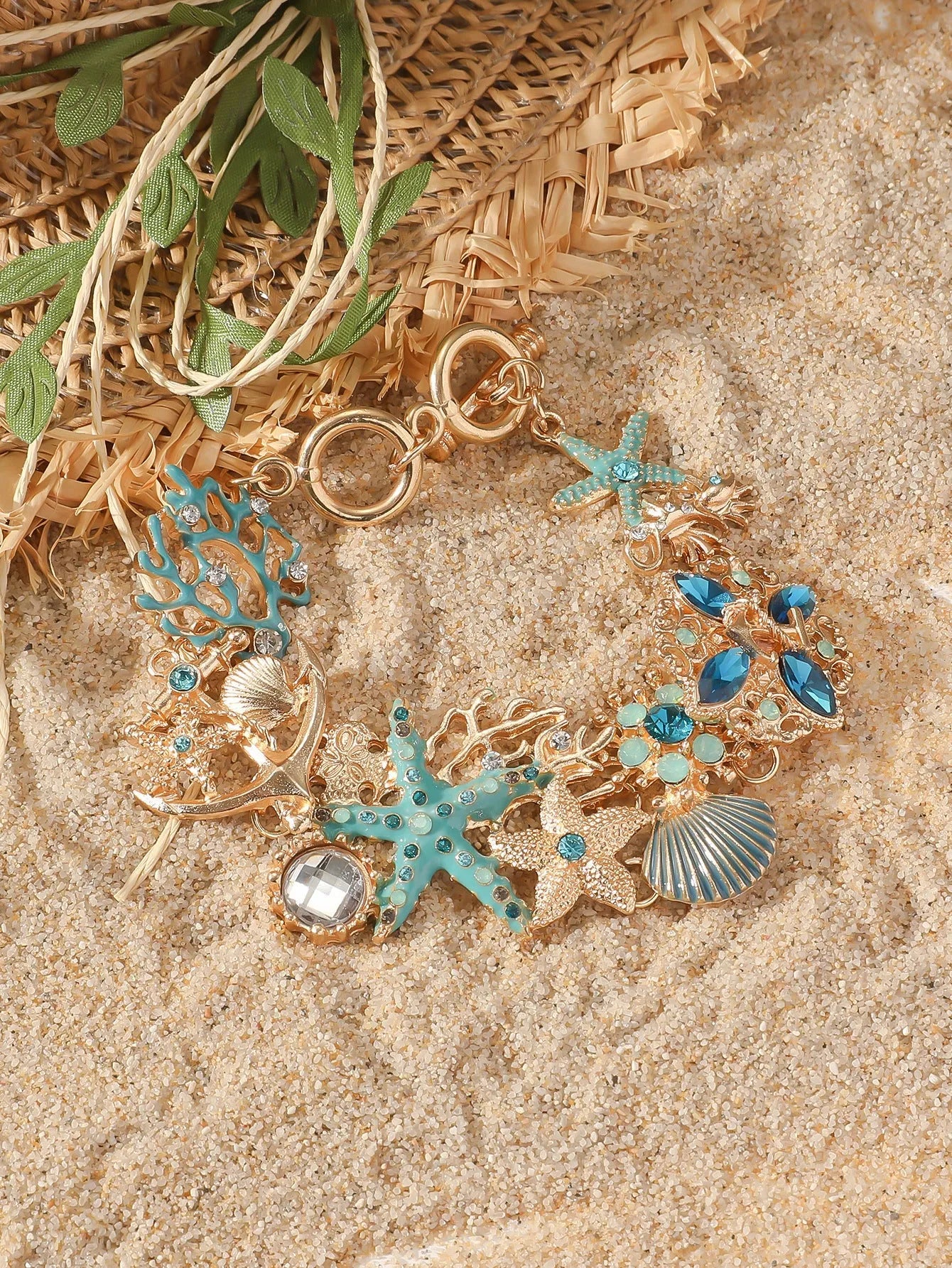 Women's alloy rhinestone marine shell and anchor bracelet with starfish charm in turquoise colour.