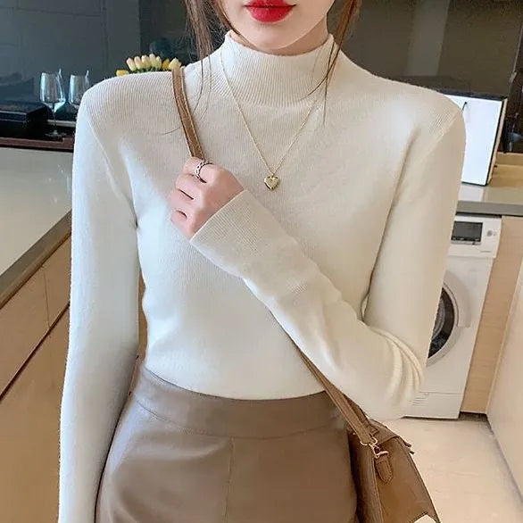Women's slim fit long sleeve knitted top in viscose fibre shown in apricot colour.