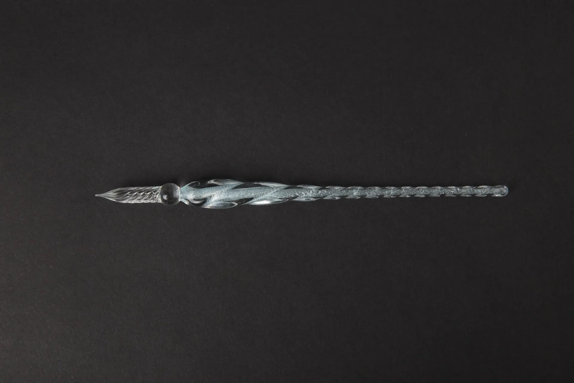 Transparent glass crystal pen with coloured ink visible inside, abstract modelling design