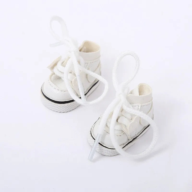A pair of 17cm high PU replacement shoes for dolls in a selected style and colour.