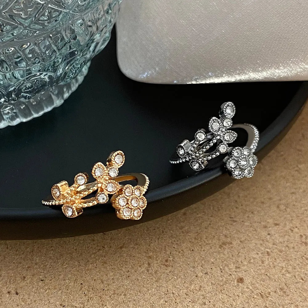 Copper open ring with diamond-treated floral leaf design in gold or white colour.