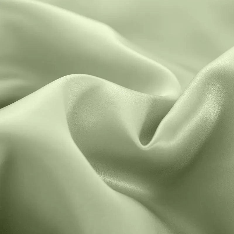 Double-sided solid colour silk duvet cover shown in Lotus Pink on a bed