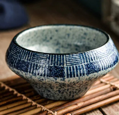 Tall porcelain Japanese soup bowl with stone conch shape and underglaze retro pattern.