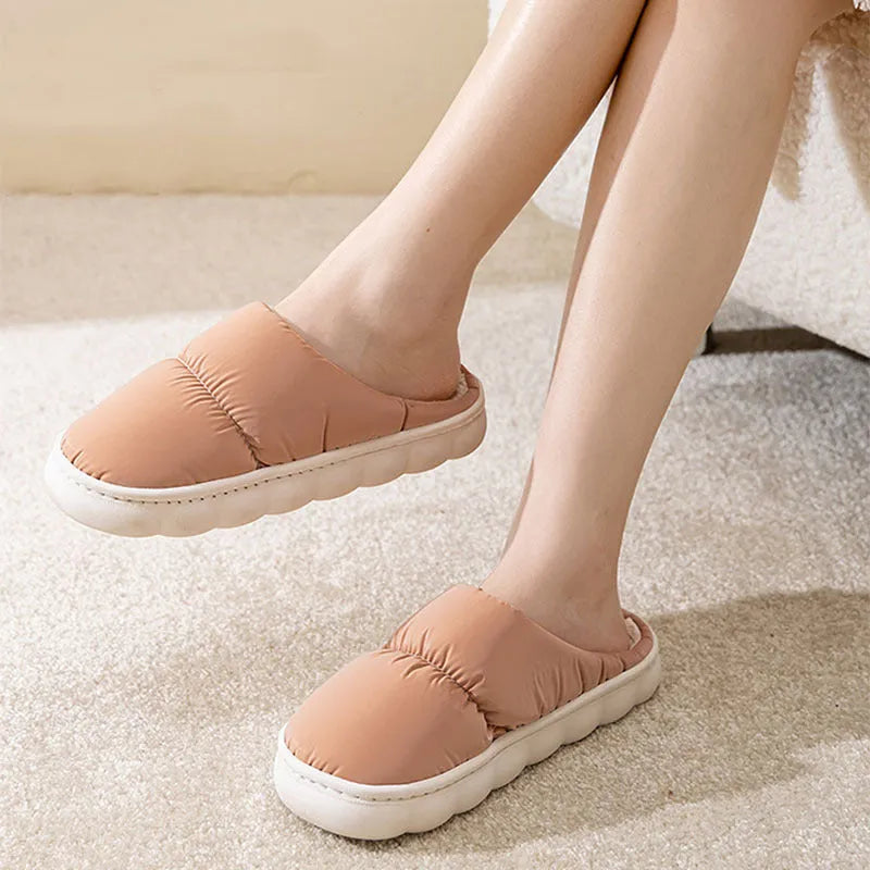 A pair of down cotton slippers with an artificial leather upper and thick rubber sole, shown in blue.