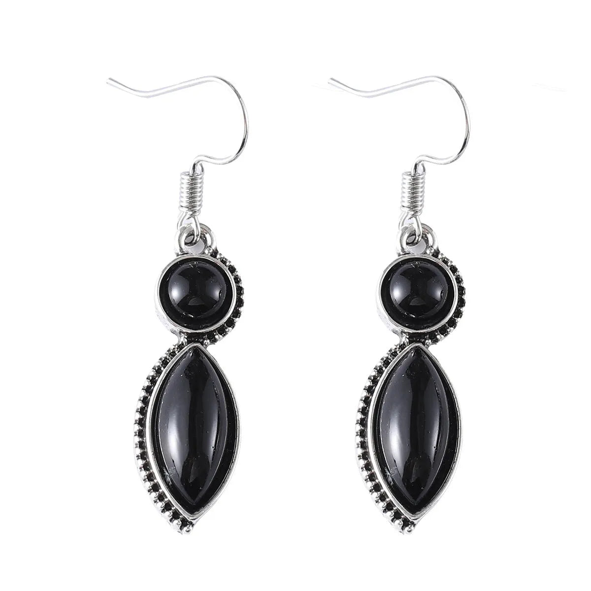 A pair of vintage geometric drop earrings with black and purple stones in a bohemian style.