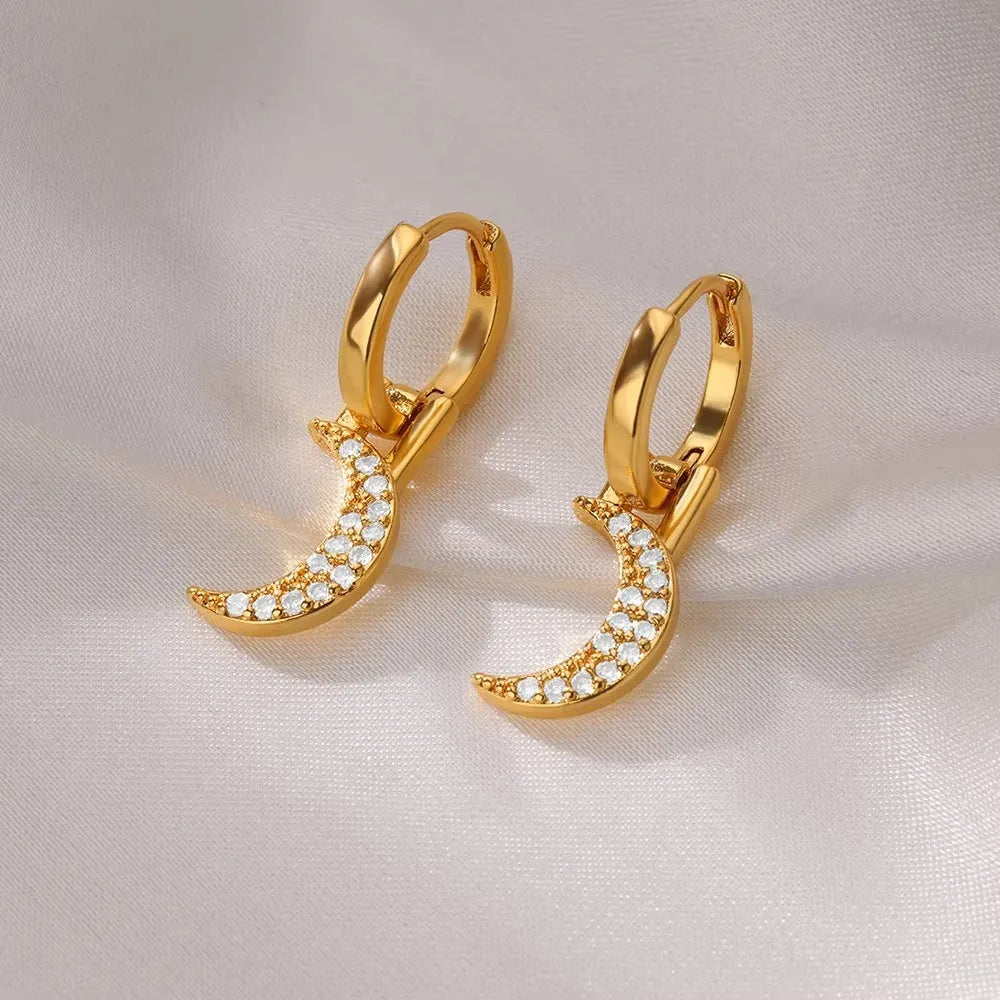 Women's geometric butterfly-shaped copper earrings with heart and star details in assorted colours.