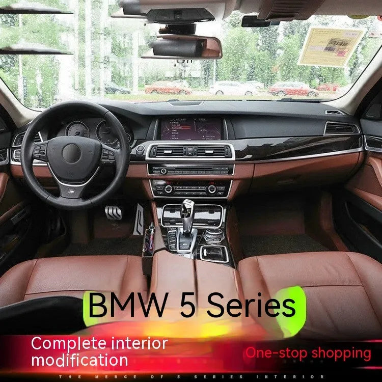 Set of four silver and black decorative trim strips for BMW 5 Series interior door handles.