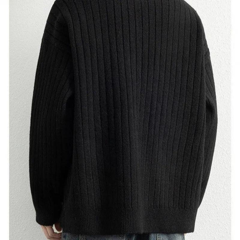 Man wearing a grey half-zip textured knit sweater, loose fit, long sleeves.