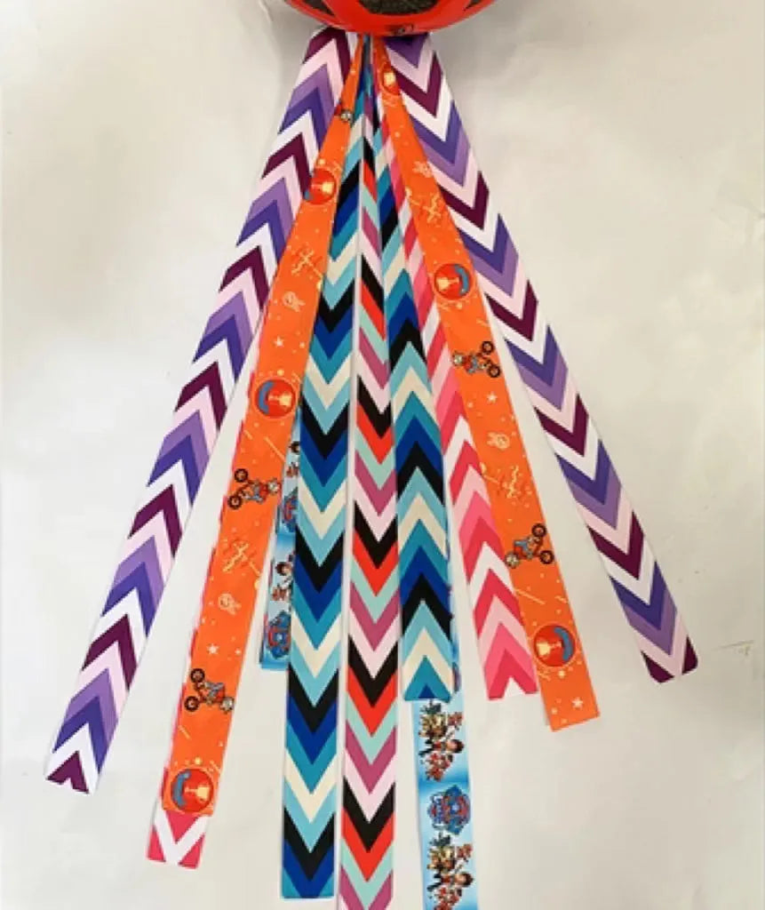 Decorative ribbon streamer for a child's ski or skating helmet in various colour options.
