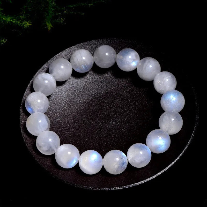 Natural white moonstone round bead bracelet showing blue moonlight sheen and polished surface