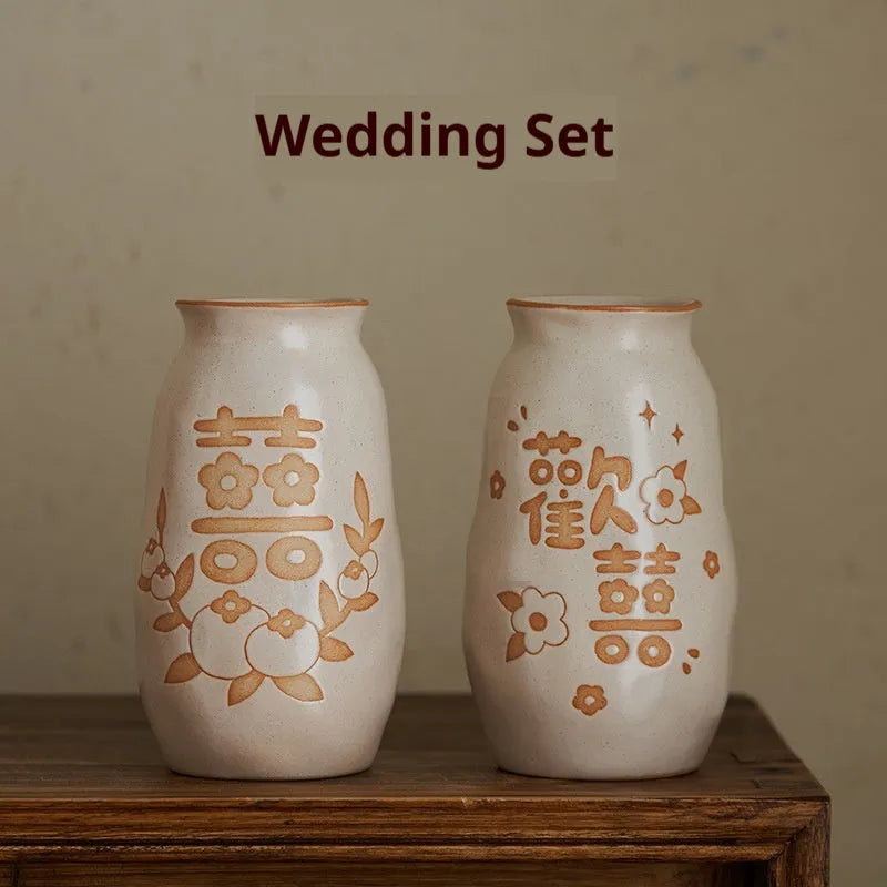 Chinese hand-painted ceramic vase with carved design on wooden desktop