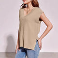 V-neck sleeveless loose pullover vest in camel or white colour with striped or plaid pattern