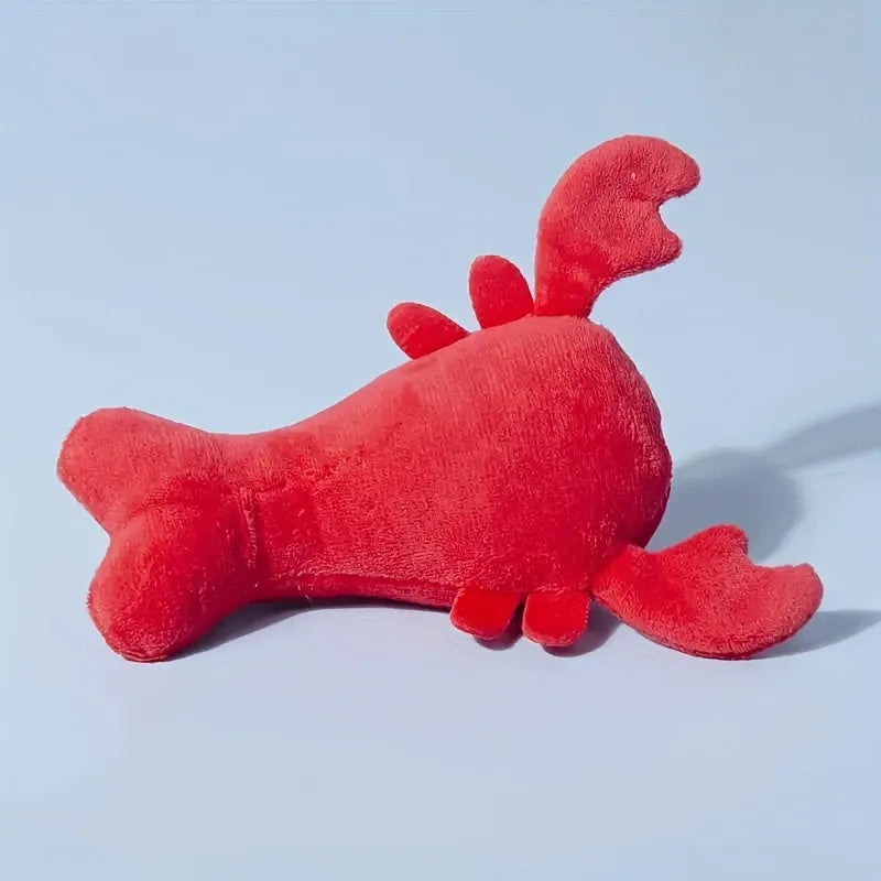 Red lobster shaped squeaky dog toy with soft plush material measuring 12.5cm length