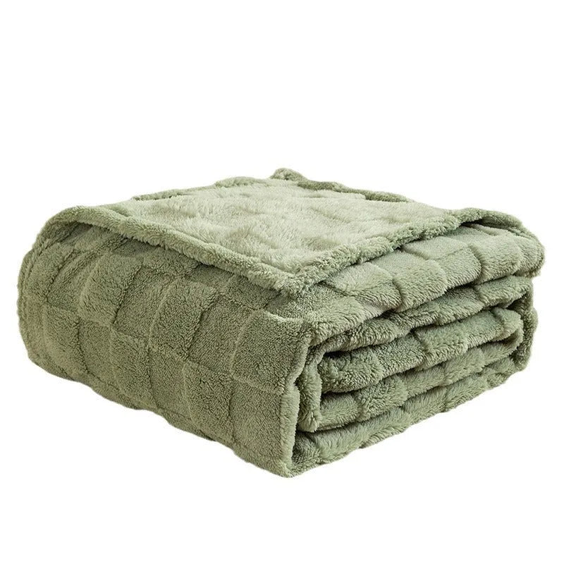 Thickened geometric pattern blanket in a neutral colour, draped over a modern sofa.