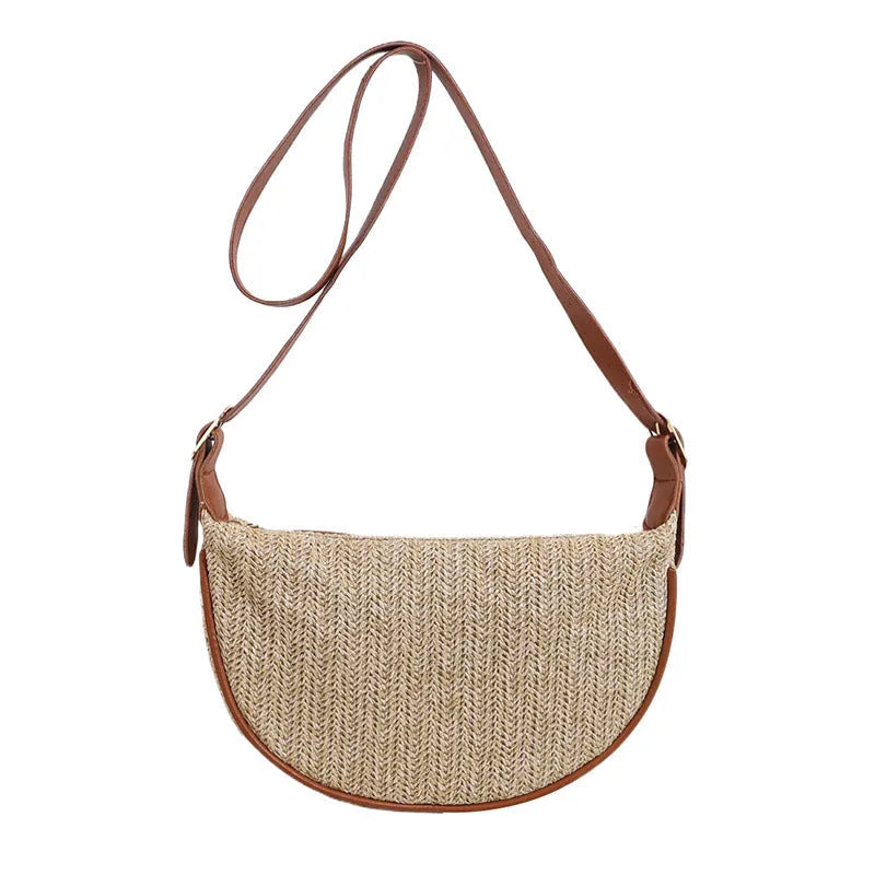 Women's woven straw crossbody bag showing internal phone and document compartments