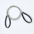 A coiled black or red survival wire saw made of braided stainless steel, shown with a scale indicating its small size.