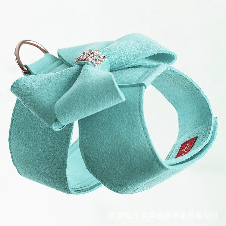 A pink microfiber dog chest strap featuring a sewn-on bowknot shaped like a puppy.
