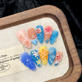 Three-dimensional carved jellyfish plastic armour set in almond nail colour, showing rose and tulip patterns.