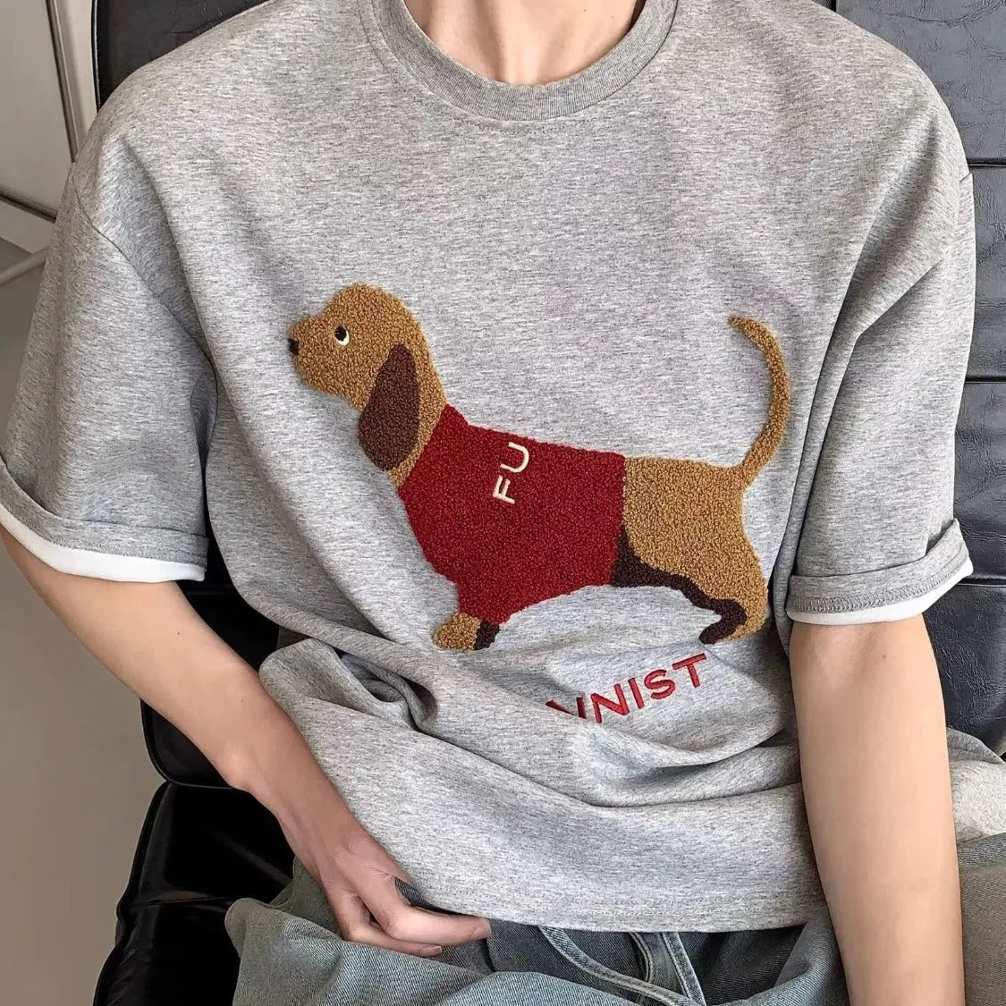 Grey men's round neck T-shirt with an embroidered dachshund dog design on the chest.