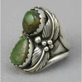 A geometric turquoise ring with a retro inlaid design on a woman's hand.
