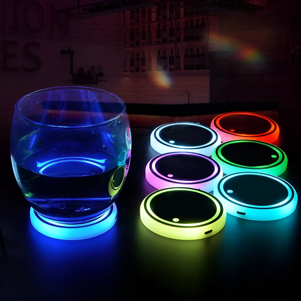 Colourful LED light-up coaster for car cup holder with USB cable on a car console.