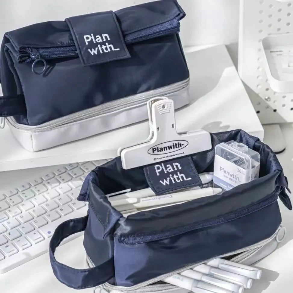 A navy blue double-layer folding pencil case made from polyester fabric for student stationery.