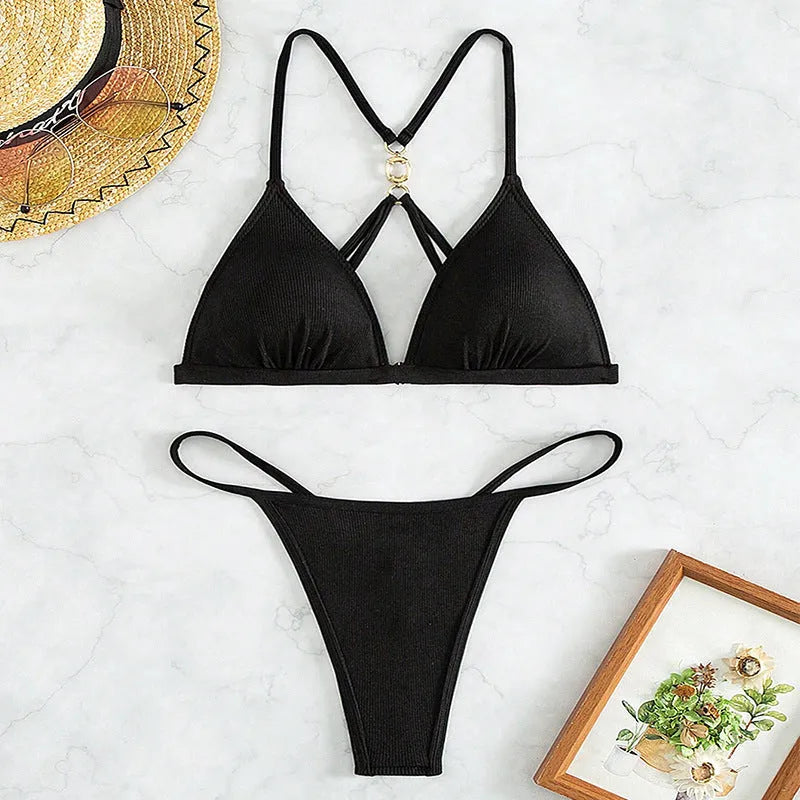 Black women's hollow backless triangle bikini swimsuit set on a mannequin.
