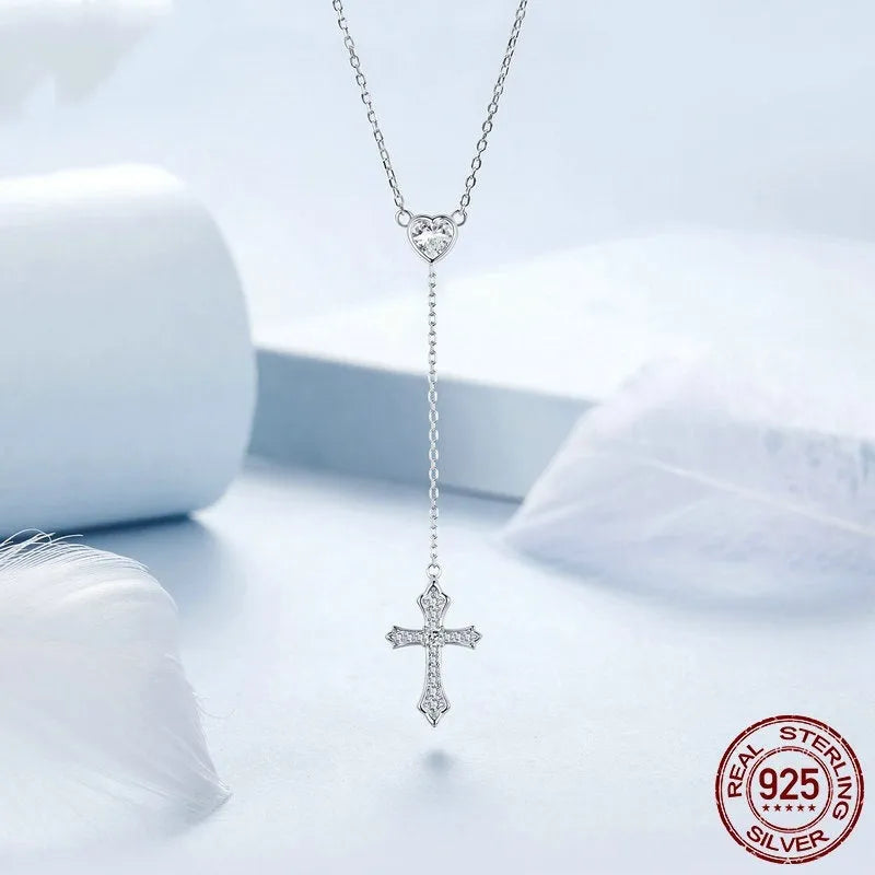 Close-up of a silver love cross necklace with an adjustable O-ring chain on an antique BSN384 finish.