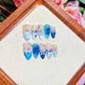 Blue transparent false nails with hand-painted carved summer ice design