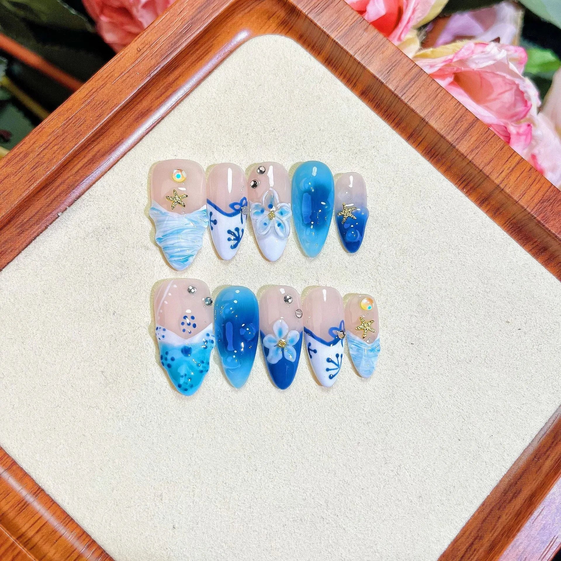 Blue transparent false nails with hand-painted carved summer ice design