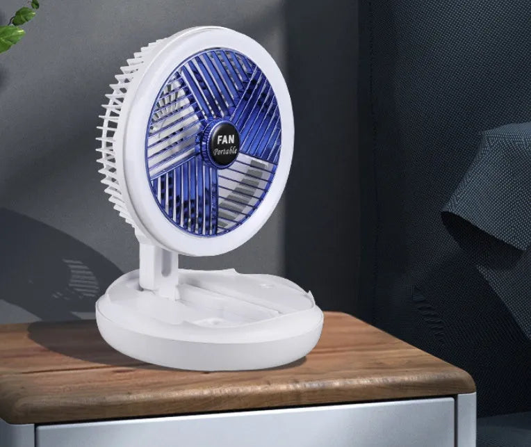 Blue foldable USB desk fan with LED light shown in open position on a table