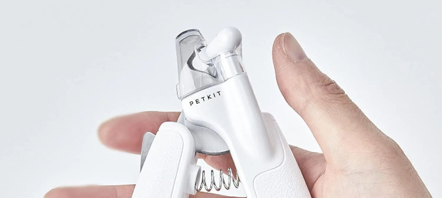 White LED pet nail clipper with a transparent anti-splash guard and a nail file on a white background.