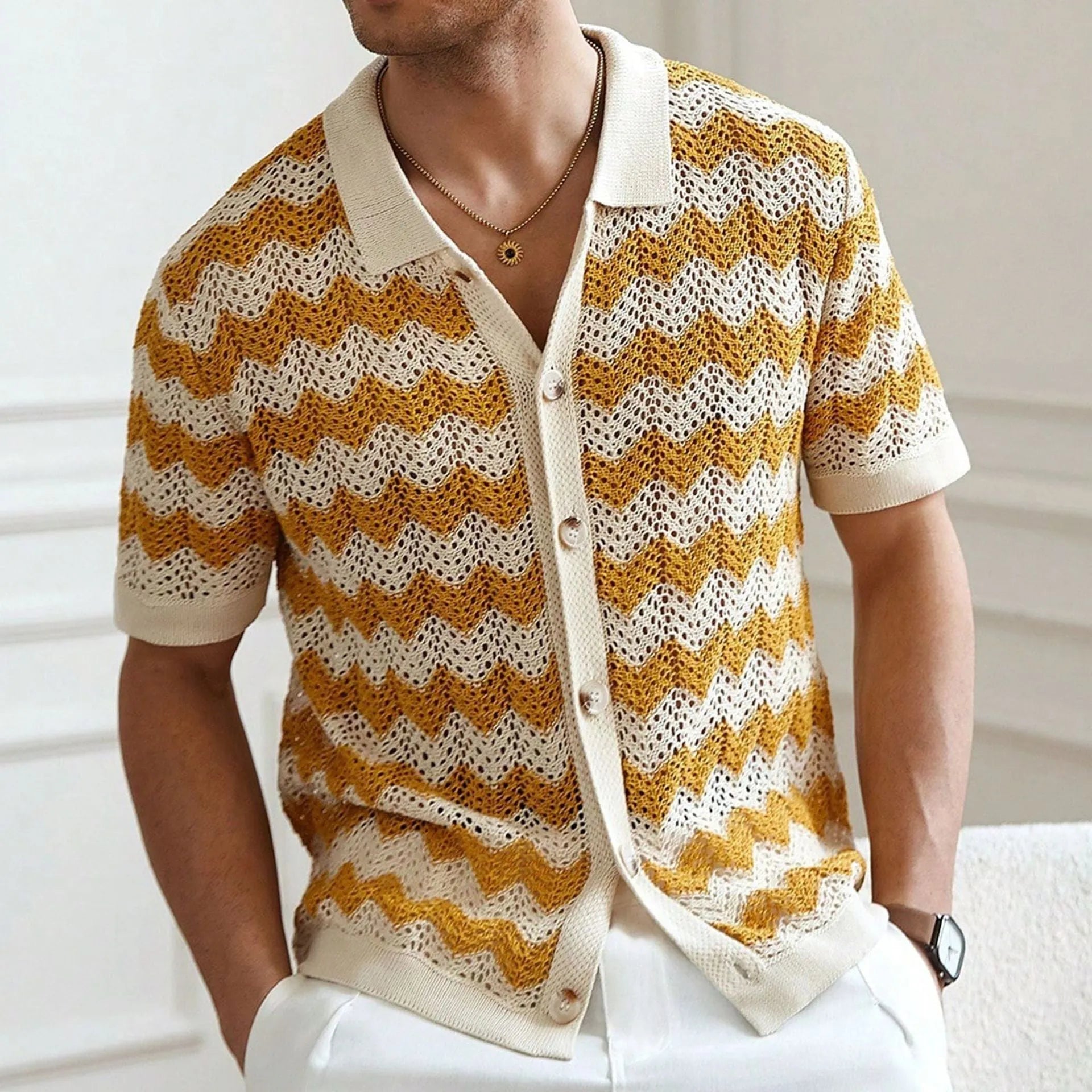 Yellow hollow jacquard corrugated short sleeve sweater with flocking detail on a hanger.