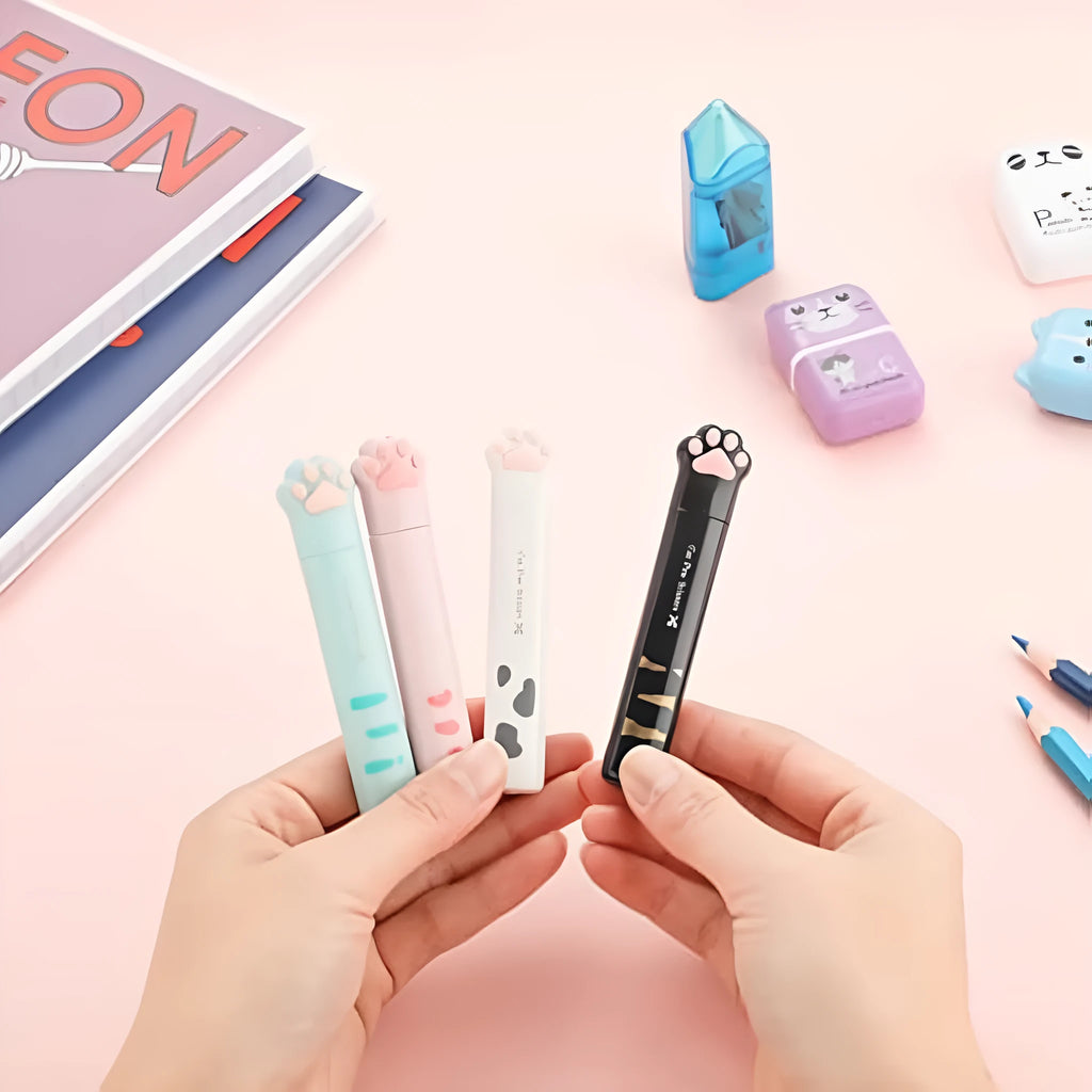 Set of four mini folding scissors with cat paw design in black, blue, pink, and white colours.