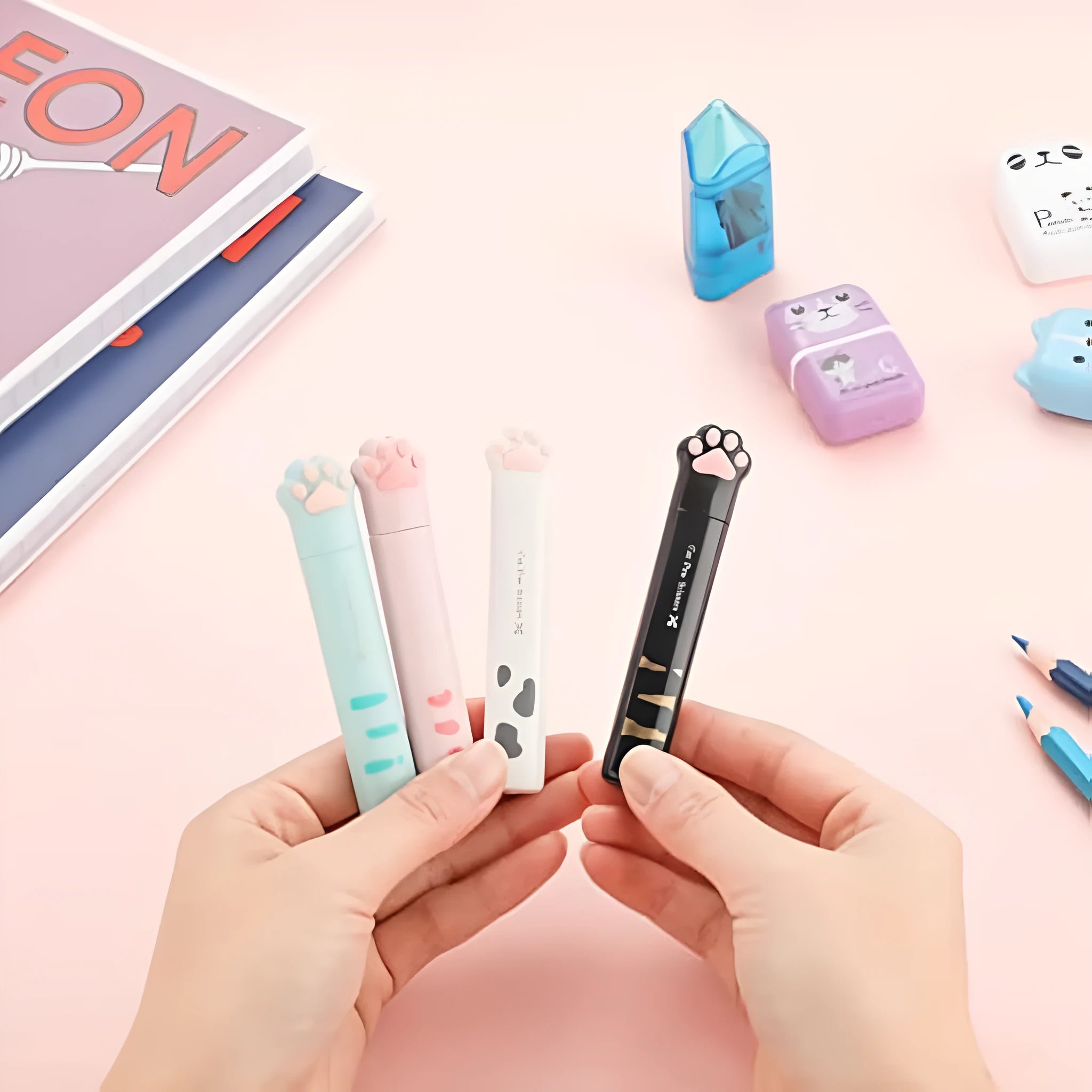 Set of four mini folding scissors with cat paw design in black, blue, pink, and white colours.