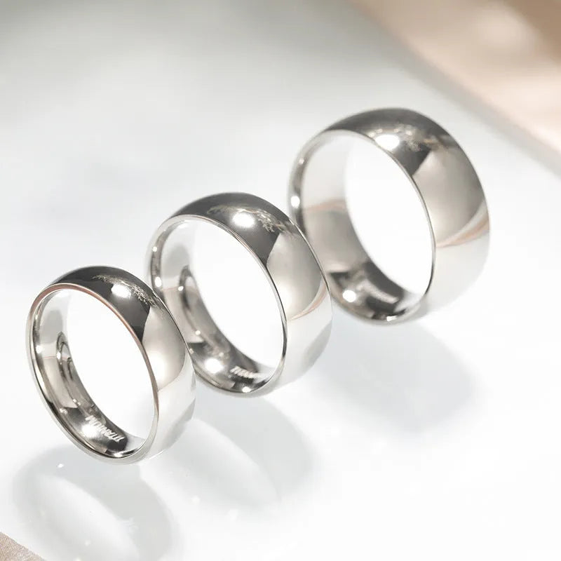 Silver titanium steel ring with matte grinding finish, shown in different width options on a finger.