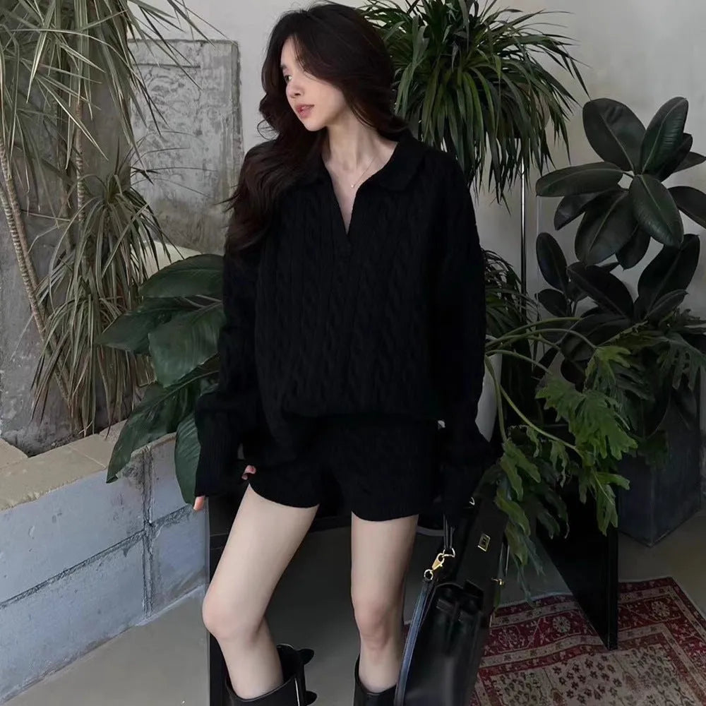 Women's knitted suit set showing cable knit jumper with geometric pattern and matching elastic waist shorts