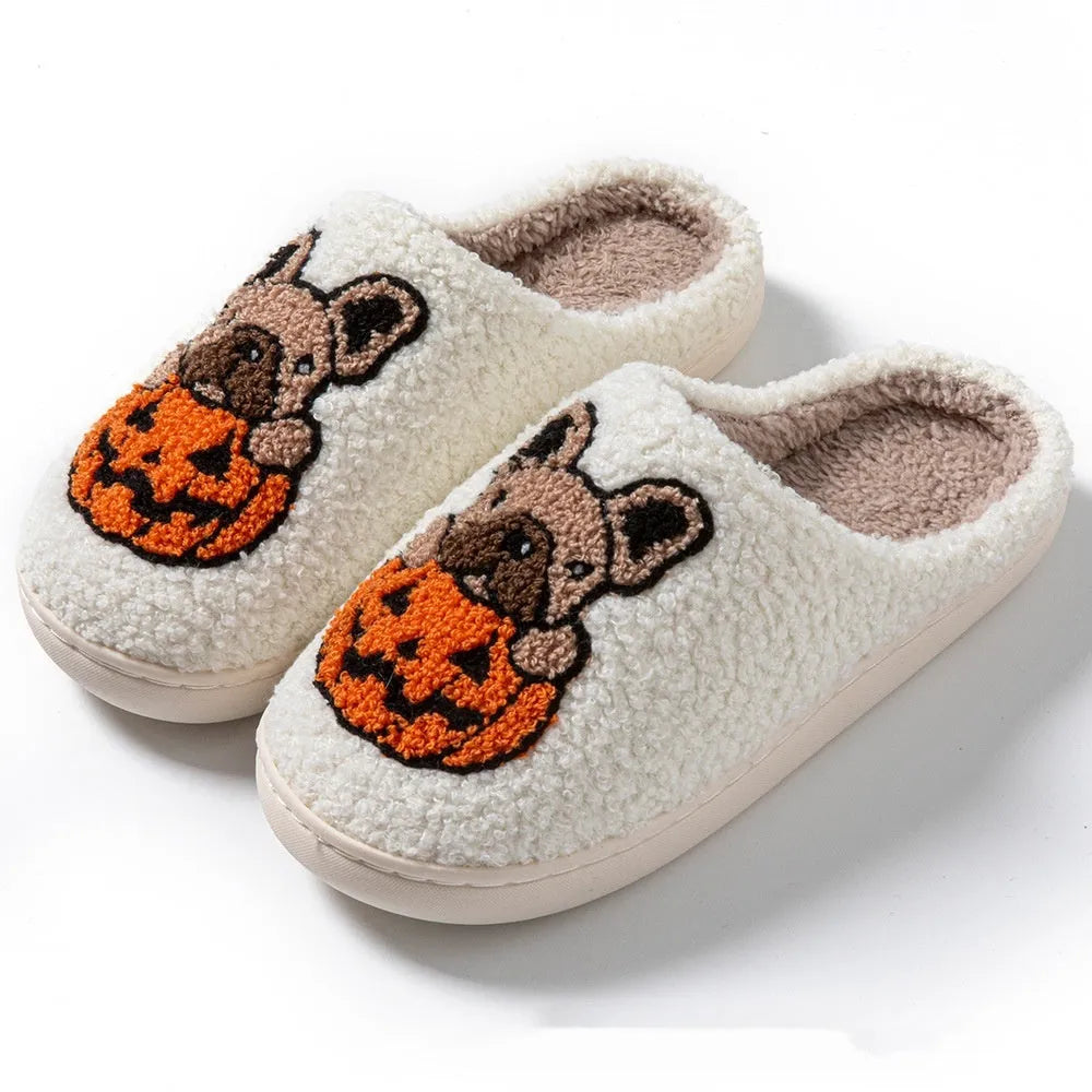 Black and white Halloween slippers with pumpkin pattern, plush upper, and textured rubber sole
