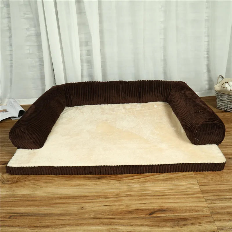 Corduroy dog sofa bed with bolster, shown in grey, placed on a wooden floor.