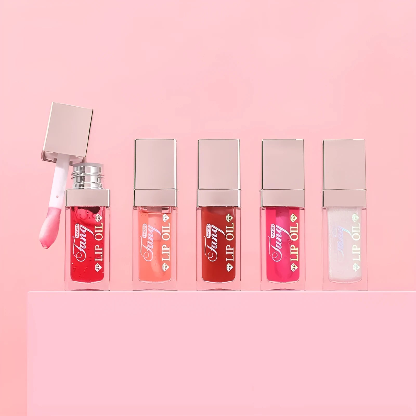 Five colour options of bright lip gloss mint lipstick with lip essence oil applicator