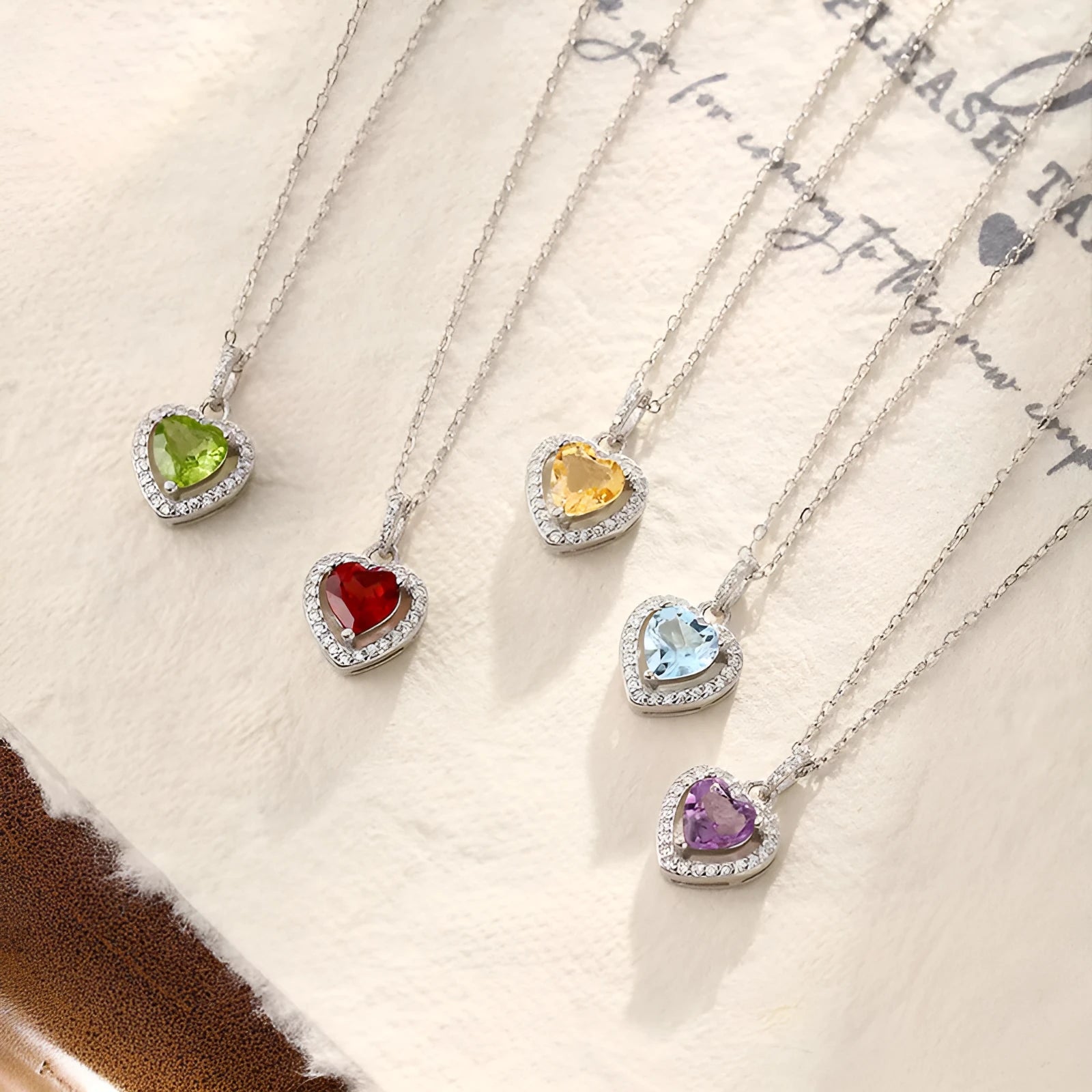 Sterling silver heart pendant necklace with a choice of coloured gemstones on a cross chain.