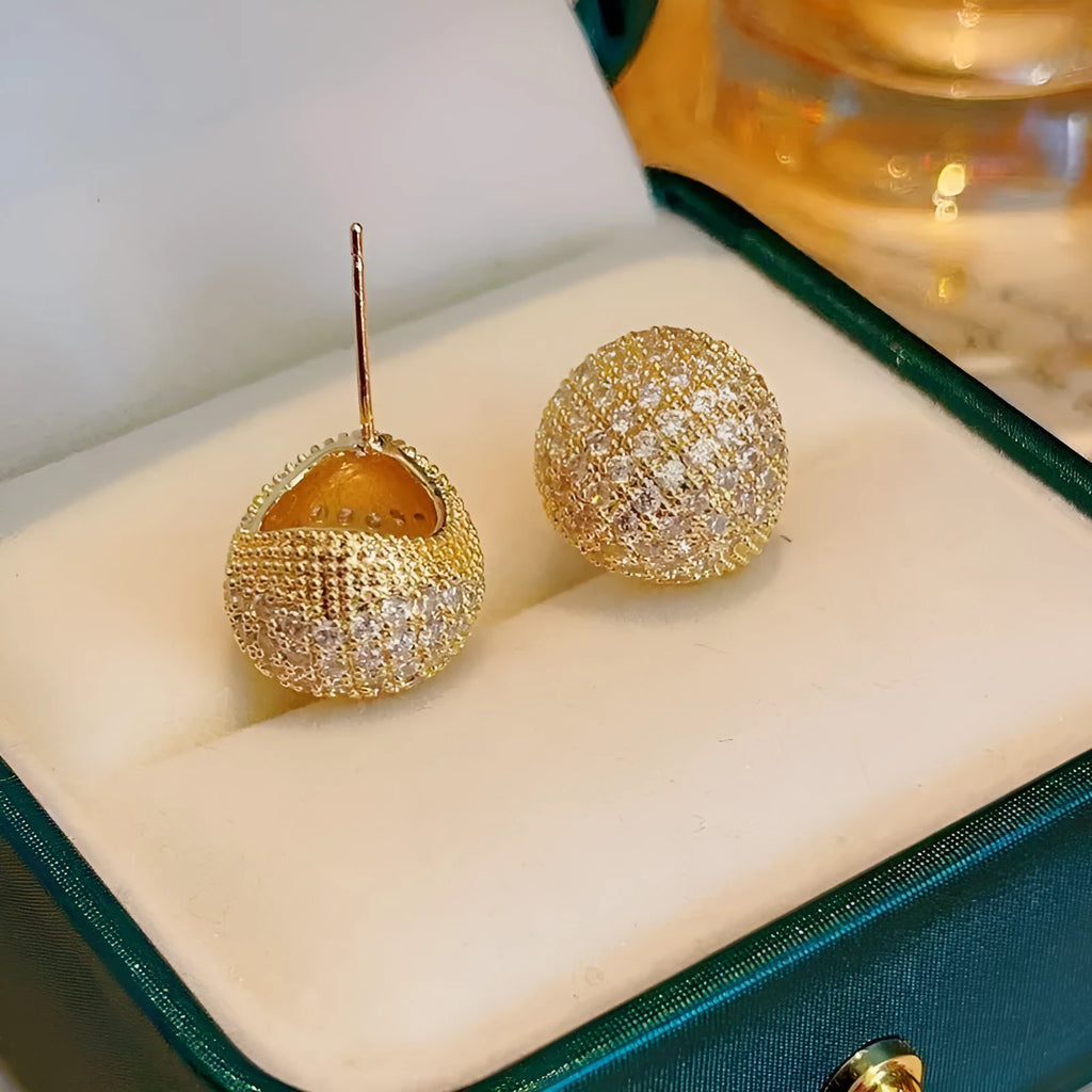 Gold and white geometric drop ear clip earrings with spherical bean design and full diamond flash