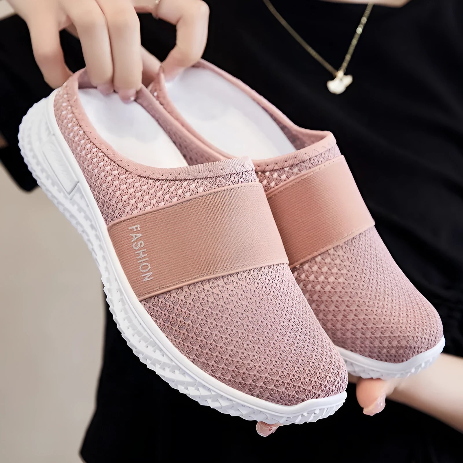 Women's flat casual shoes in mesh fabric with hollow-out design on a round toe.