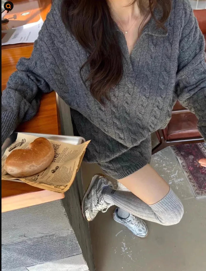 Women's knitted suit set showing cable knit jumper with geometric pattern and matching elastic waist shorts