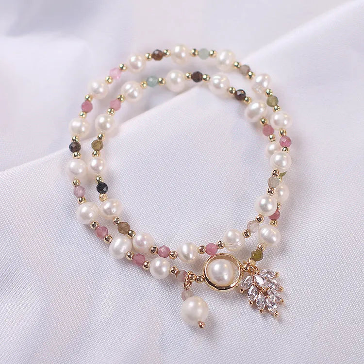 Women's double layer strawberry quartz bracelet with lucky cat charm in red cat's eye flowers colour.