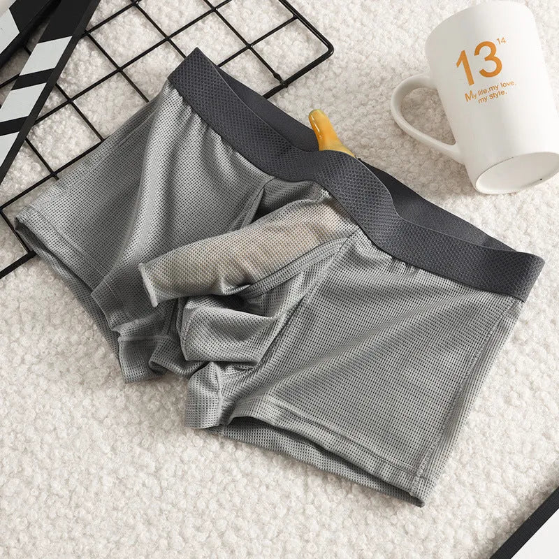 Men's solid colour ice silk mesh boxer underwear on a grey background, showing low waist design.