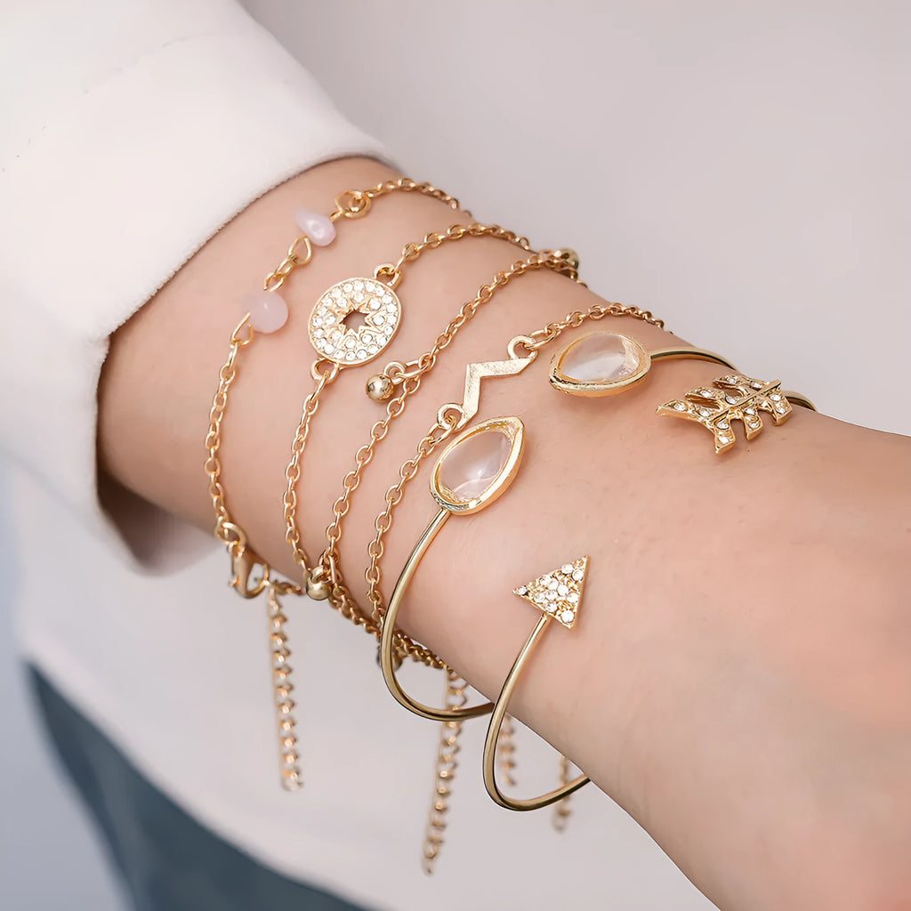 Gold zinc alloy bracelet set with six charms including spot drill, arrow, and water drop shapes.