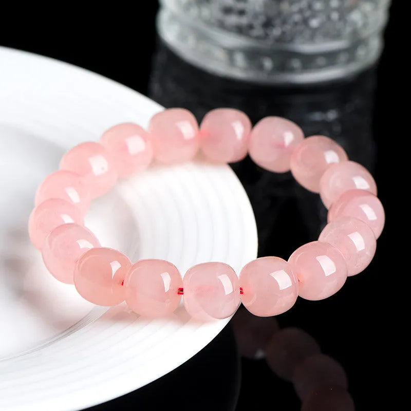Natural pink crystal bead bracelet with geometric barrel-shaped design measuring 8-10mm per bead