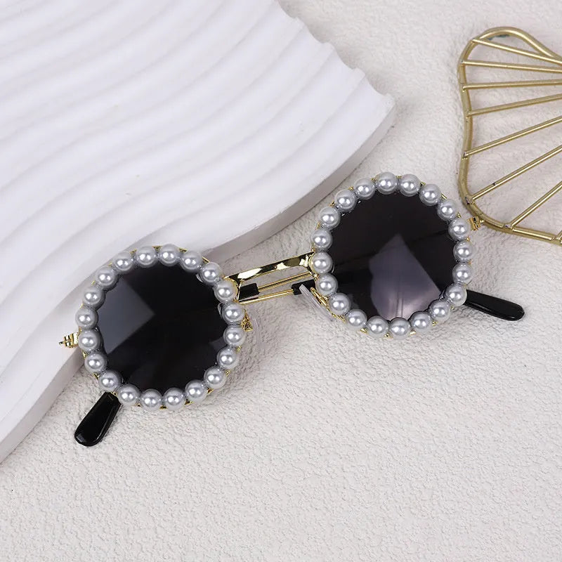 Pearl-rimmed round sunglasses on a cat and dog for costume dress up